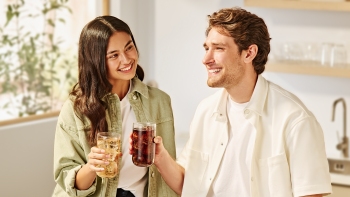 Two-people-enjoying-drinks-in-kitchen